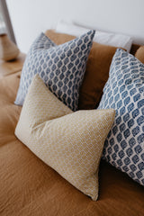 French linen cushion on bed
