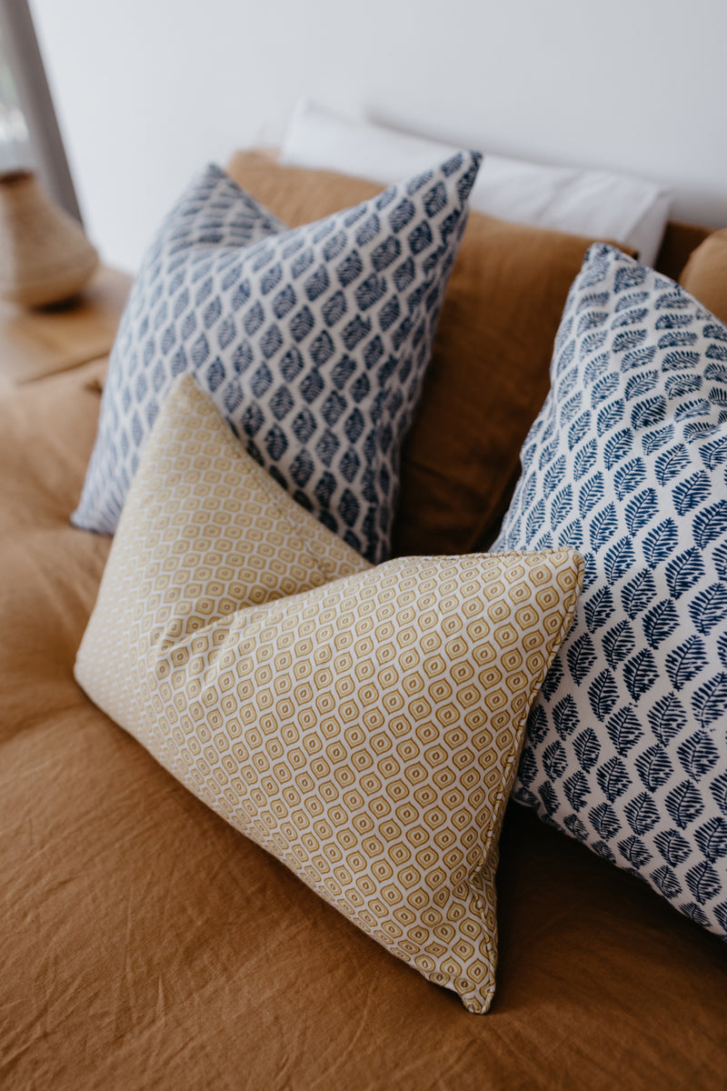 French linen cushion on bed